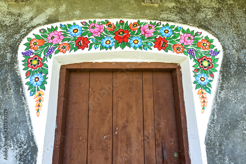 Fotografering Painted old cottage decorated with a hand painted colorful floral motives, folk
