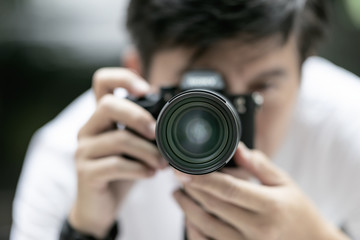 Close up view of  photographer taking a photo with his camera on tripod