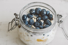 Overnight Oats With Bluberry Soaked In Coconut Milk In A Glass Jar. Vegan Friendly Breakfast. Oatmeal