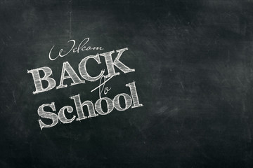 Inscription Back to school, chalk scribble background on blackboard. The concept of the day of knowledge, September 1, the beginning of classes.