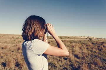 Traveler woman using binoculars