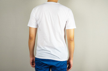 Man wearing empty white t-shirt, standing back