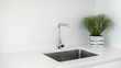 Modern kitchen sink and faucet with decorative flowers.