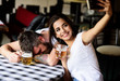 © be free - Girl taking selfie photo drunk boyfriend. Take selfie to remember great event. Man drunk fall asleep table and girl with full beer glass. He appears too weak for her. Woman making fun of drunk friend