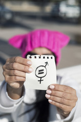 Wall Mural - woman with pussyhat and symbol for gender equality.