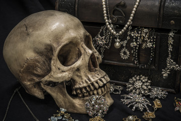 Still life with a human skull with old treasure chest and gold, diamond