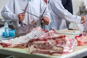 Meat beef Thai-French or Ko Khun Phon Yang Kham at Sakon Nakhon Thailand. And the butcher cutting raw meat beef in the butchery shop.