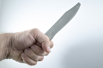 The hand holds a knife, the weapon of crime. Photo for a criminal article.