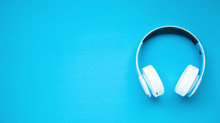 White Headphones On A Blue Background.