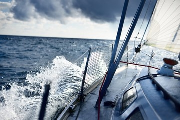 Wall Mural - Stormy weather on the sea. A view from the sailboat's deck to the bow, Norway