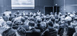 Round table discussion at Business convention and Presentation. Audience at the conference hall. Business and entrepreneurship symposium. Black and white blue toned image.