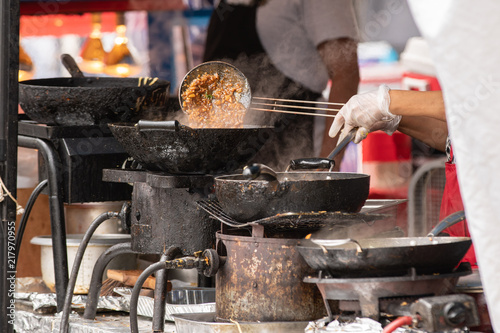 Fotografie, Obraz Oriental chicken food made to order at outdoor festival.