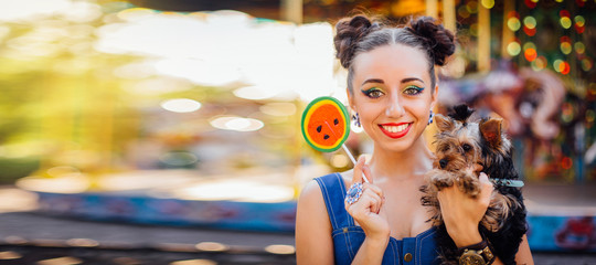 Wall Mural - Bright makeup beautiful girl with Yorkshire Terrier holding watermelon lollipop.