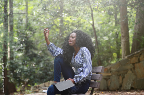 Fotografie, Obraz Stylish black woman reading book expressively