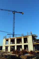 Large construction site including several cranes working on a building complex