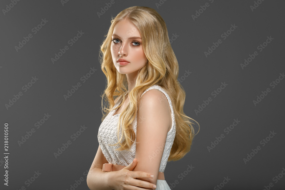 Beautiful woman with long blonde hair over gray background beauty female - obrazy, fototapety, plakaty 