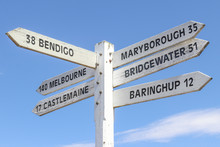 Painted Wooden Signpost At Maldon Town Centre Showing Distance And Directions To Surrounding Towns And A Blue Sky