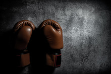Boxing Gloves On Texture Background With Copy Space. Don’t Give Up Or Defeat Concept.