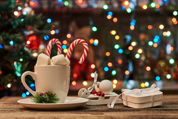 Wall Mural - Hot Chocolate with marshmallows and candy stick, traditional beverage for winter time.