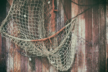  Hanging Fishnet On Wood Wall. Background And Texture For Text Or Image.