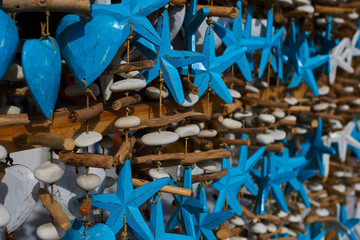 Wall Mural - Various souvenirs displayed in an shop. Colorful souvenir background. Collection of colorful wooden different things in the market. Stars and hearts decorated. Handicrafts of Bali. Selective focus.