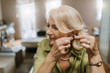 © Westend61 - Senior woman applying hearing aid