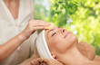 © Syda Productions - beauty, spa and wellness concept - close up of beautiful woman having face massage with sponge over green natural background