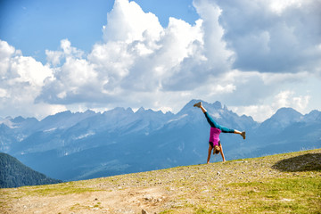 Wall Mural - young woman jumping in the mountains