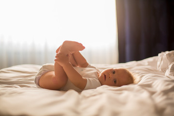 Canvas Print - Beautiful baby boy, lying in bed, playing in bed after bath, sleeping