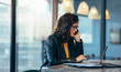 © Jacob Lund - Asian woman busy working at her desk