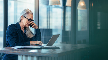 senior business woman talking on cell phone