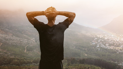 Man looking at the city view from mountain