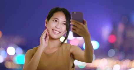 Canvas Print - Woman use of mobile phone with taking selfie at night