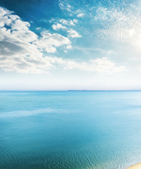 aerial view to blue sea and clouds in sunset