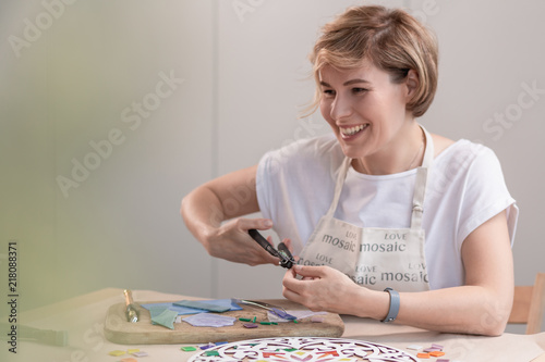 Fotografia, Obraz Portrait of master working on new modern colorful mosaic