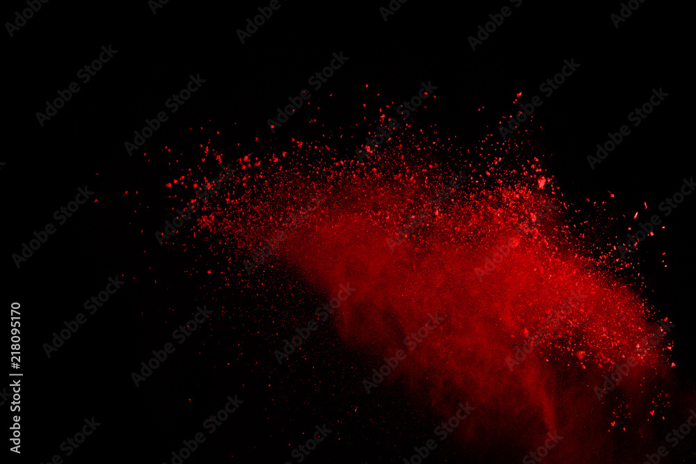 Abstract of red powder explosion on black background. Red powder ...