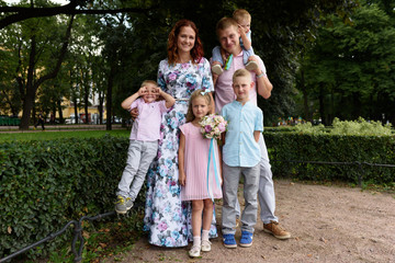 Wall Mural - happy caucasian family in park