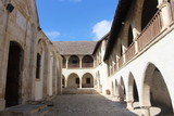 Fototapeta Na drzwi - Courtyard of Timios Stavros Monastery, located near the mountain village Omodos, surrounded by two-story buildings with arcades.