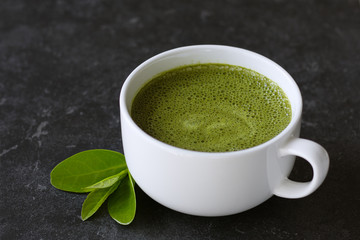 Hot green tea matcha latte in a cup