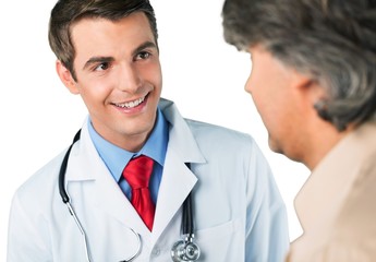 Wall Mural - Portrait of a Young Doctor Talking with Mature Patient