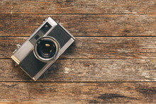 Vintage Black And Silver Range Finder 35mm Camera On Weathered Wooden Background