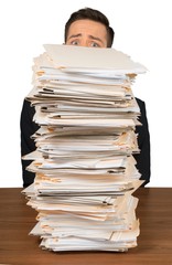 Poster - Portrait of a Worried Employee Behind a Stack of Documents