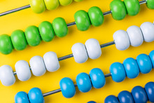 Colorful Wooden Abacus Beads On Yellow Background, Business Financial Or Accounting Profit And Loss Concept, Or Use In Education School Arithmetic Symbol