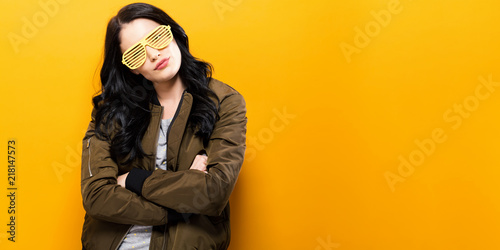 Fotomural Fashionable woman in a bomber jacket on a golden yellow background