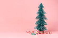 Christmas Tree With Candy Cane On Pastel Pink Studio Background.Holiday Festive Celebration Greeting Card With Copy Space To Addng Text.