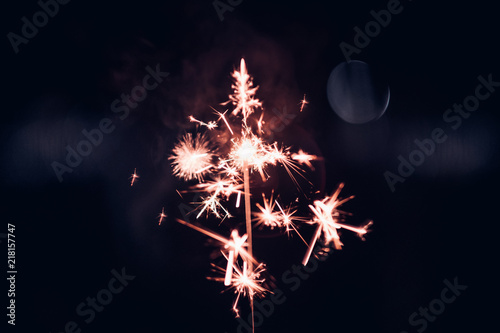 Hand holding burning Sparkler blast on a black background at night,holiday celeb Billede på lærred