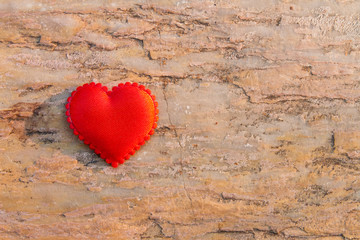 Red heart on a brown stone