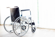 A Wheelchair Is Parking At Hospital Room Or House Near Curtain And Window In The Evening With Copy Space. Wheelchair Suit For Old People, Disabled, Patient. It’s Important And Useful Thing For Them.