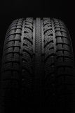 Close-up of car tire over black background