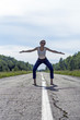 © Irina - the girl stands on the road going into the distance